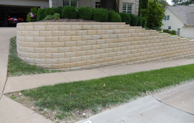 A Stone Retaining Wall in Front of a Charming House